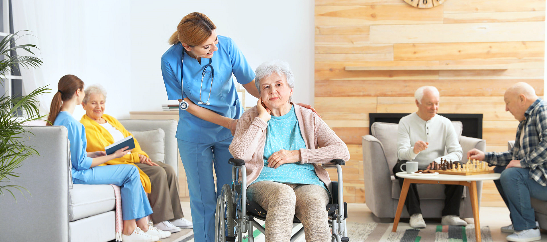 physical therapist assisting patient on a wheelchair